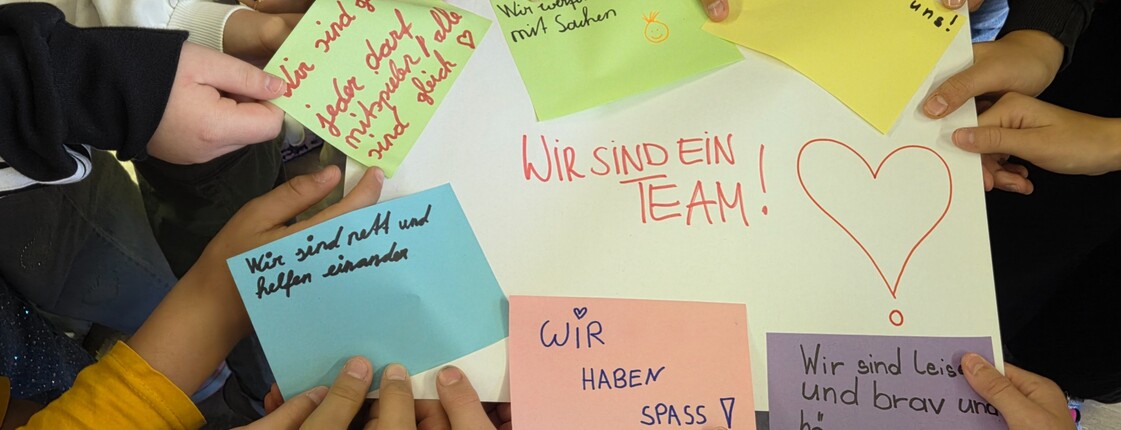Hände, die ein beschriftetes Plakat und Zettel halten