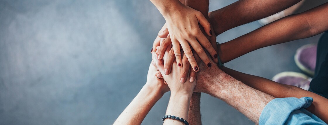 Stack of hands showing unity and teamwork Stack of hands showing unity and teamwork